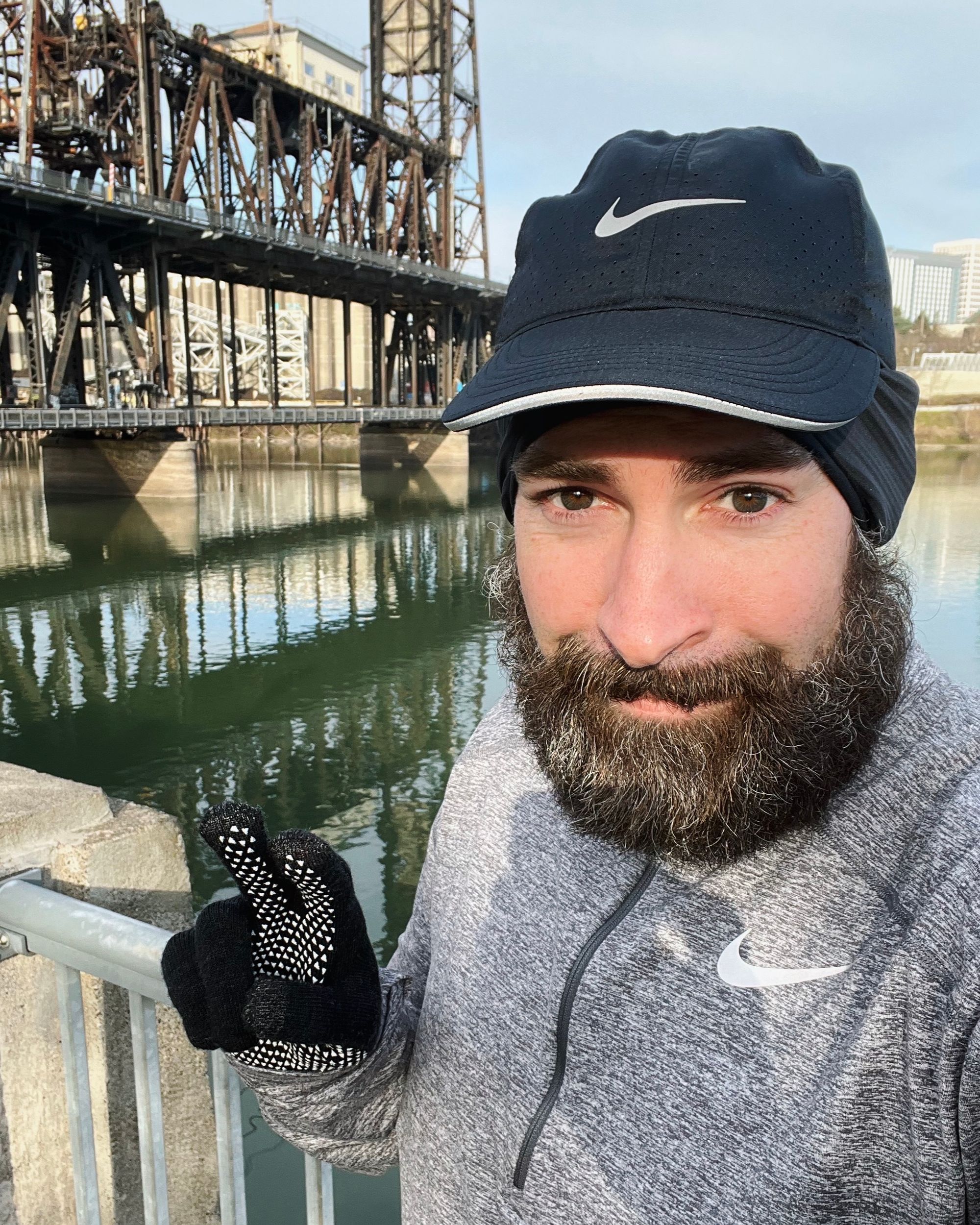 The author, out on a run, stopping for a photo with the bridge in cold Portland weather.